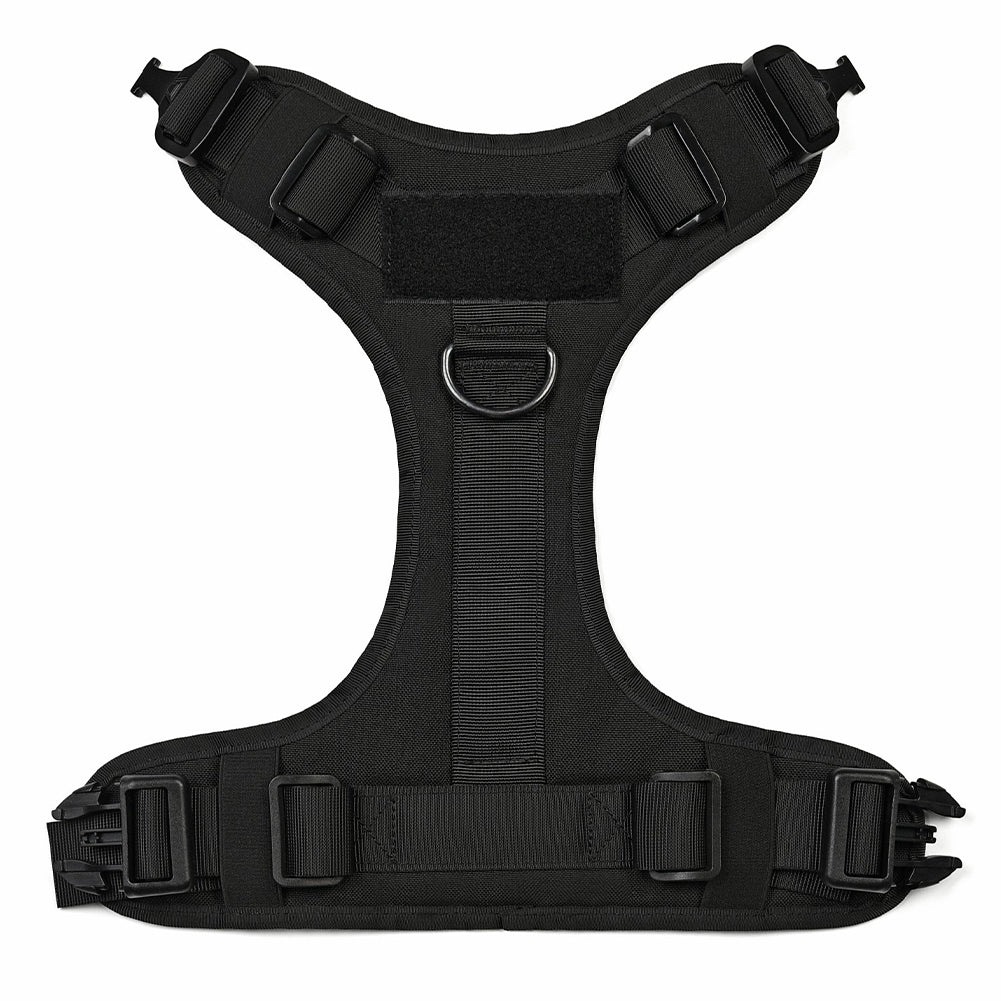 Chest panel of the Blacktop Everyday Harness laid flat, showing the front D-ring, the velcro patch panel and the quick-release buckles. Photographed in black; the same build on every colour.