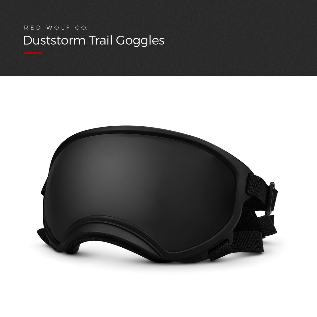 Smoke — Duststorm Trail Goggles, black frame with smoke tinted lens and adjustable straps, three-quarter view, under a Red Wolf Co. title banner