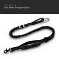Blackout — Slackline Bungee Lead laid out full length, showing the elastic section, reflective stitching, seatbelt buckle, carabiner and padded handle, under a Red Wolf Co. title banner