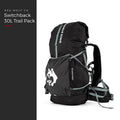 Blackout — Switchback 30L Trail Pack from the front three-quarter, roll-top closed, grey compression straps and padded hip belt, under a Red Wolf Co. title panel