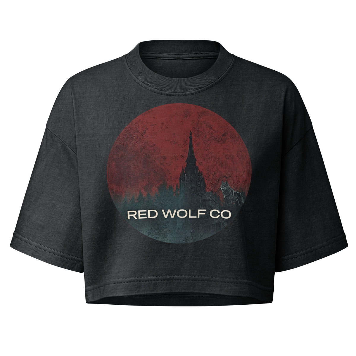 Women's Solace Cropped Tee in washed black, laid flat from the front, with the circular Red Wolf Co wolf-and-red-moon badge across the chest